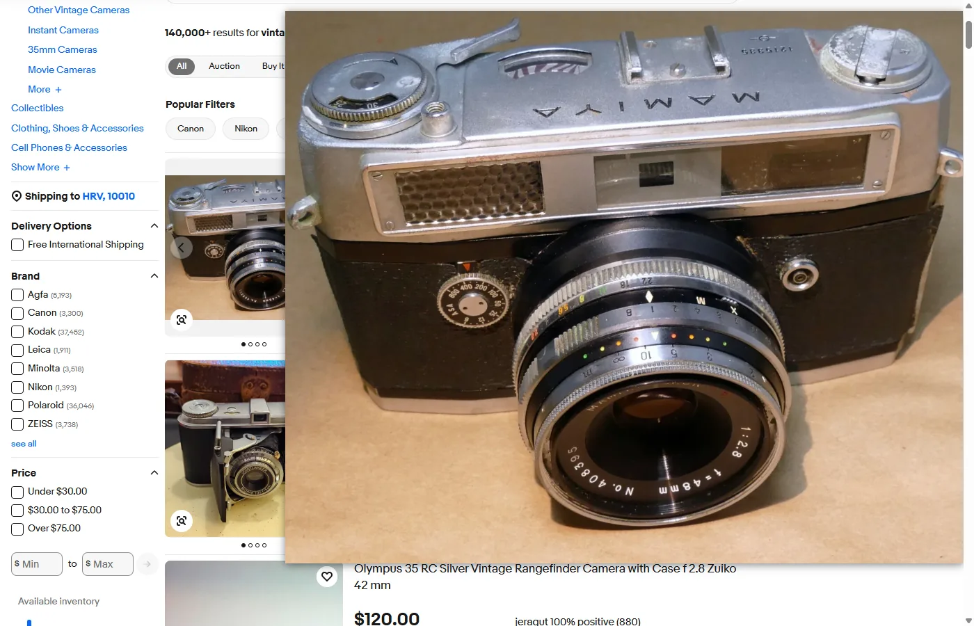 An eBay search for vintage camera: Bellevue's hover popup shows the first result, a Mamiya Ruby rangefinder, from its 1600-pixel copy over the results, where the same photo is 256 pixels wide, with the lens's engraved serial number and the corrosion on the shutter dial legible in the popup