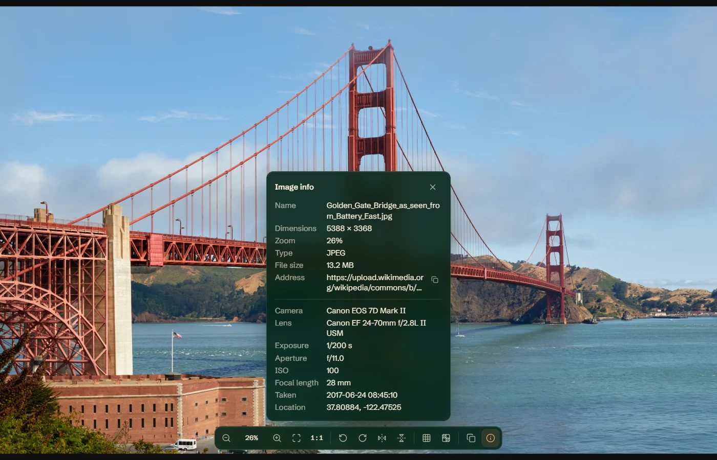 A photo of the Golden Gate Bridge in Bellevue at 26%, with the toolbar along the bottom edge and the image info panel open above it, listing the file's name, dimensions, type and size, and the camera, lens, exposure, aperture, ISO, focal length, date and location recorded in the photo