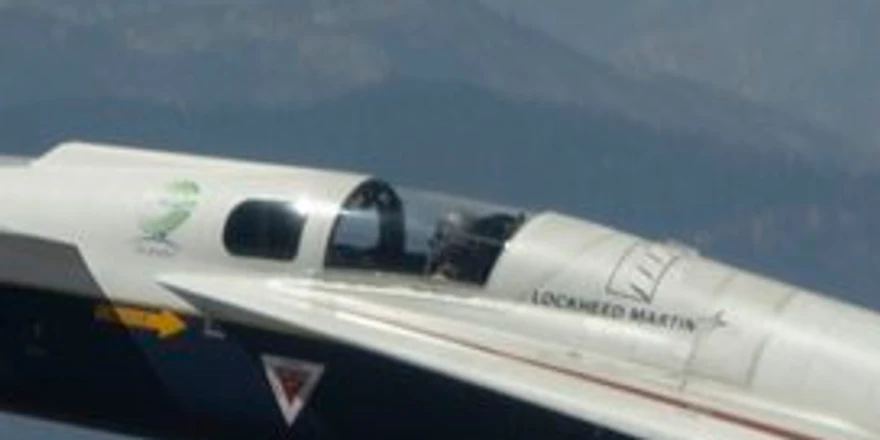 The X-59's cockpit cut from the name=large copy, where the pilot's helmet and the small lettering on the fuselage are smeared
