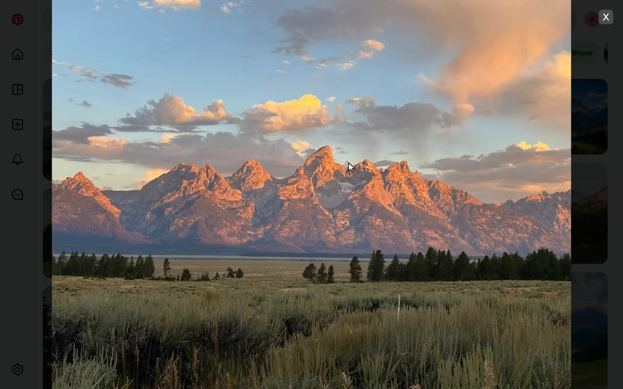 A Pinterest pin of a mountain range at sunset, open full-screen in Bellevue's viewer and zoomed in, with the dimmed pin grid behind it